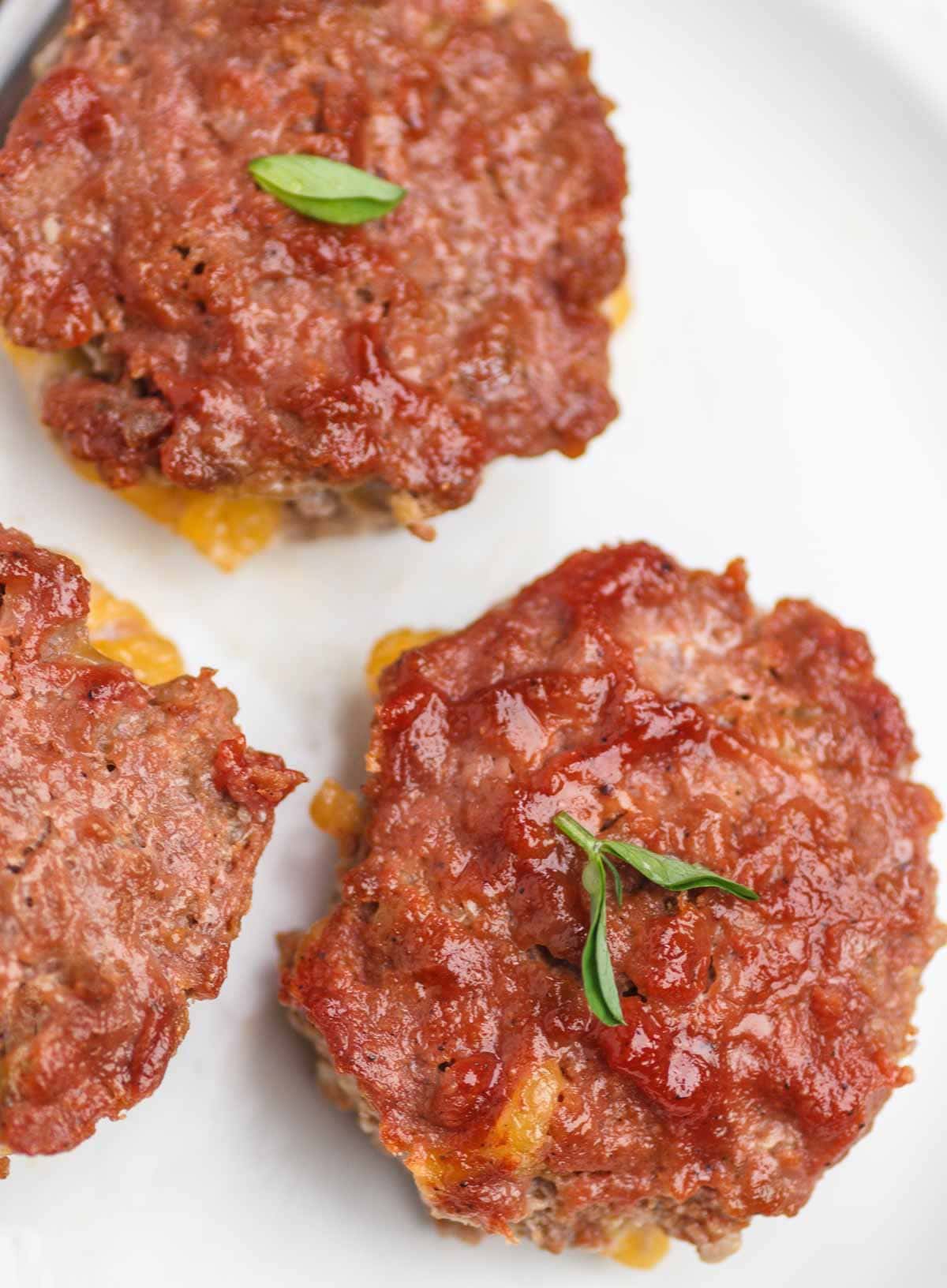 Cheese filled muffin pan meatloaf minis with tomato glaze.