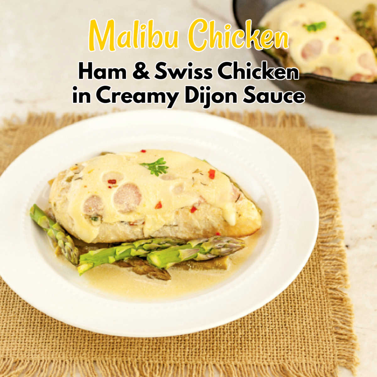 A plate with ham and swiss chicken  and asparagus in a Dijon cream sauce.