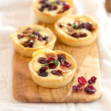 Low carb tartlets with bacon, melted cheese and dried cranberries.