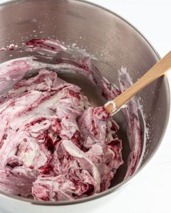 Adding most of blackberry puree to whipped cream, and folding in..