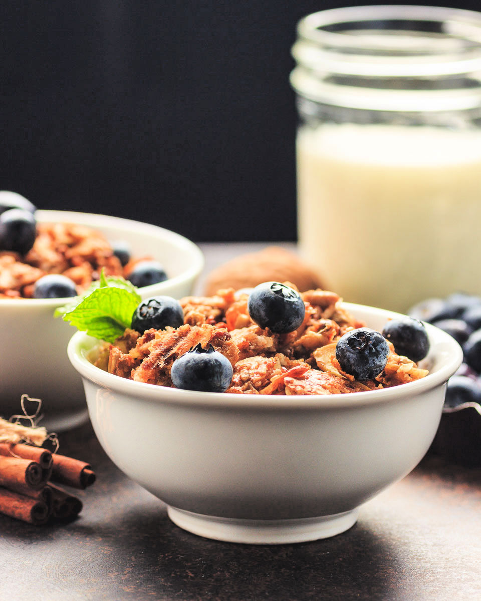 bowls of low carb cereal with berries and nut milk.