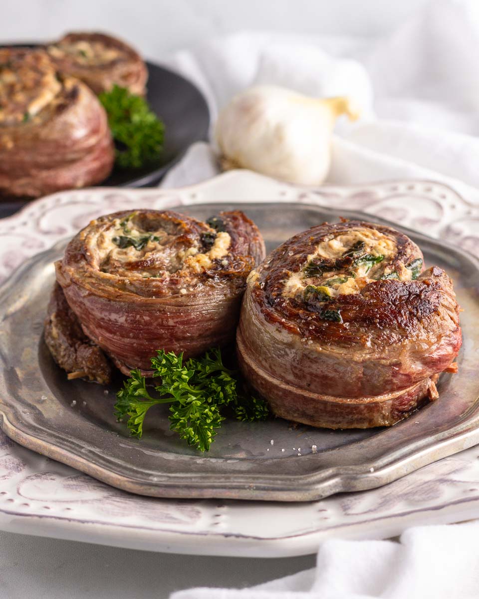  Two spinach cheese stuffed flank steak rolls.
