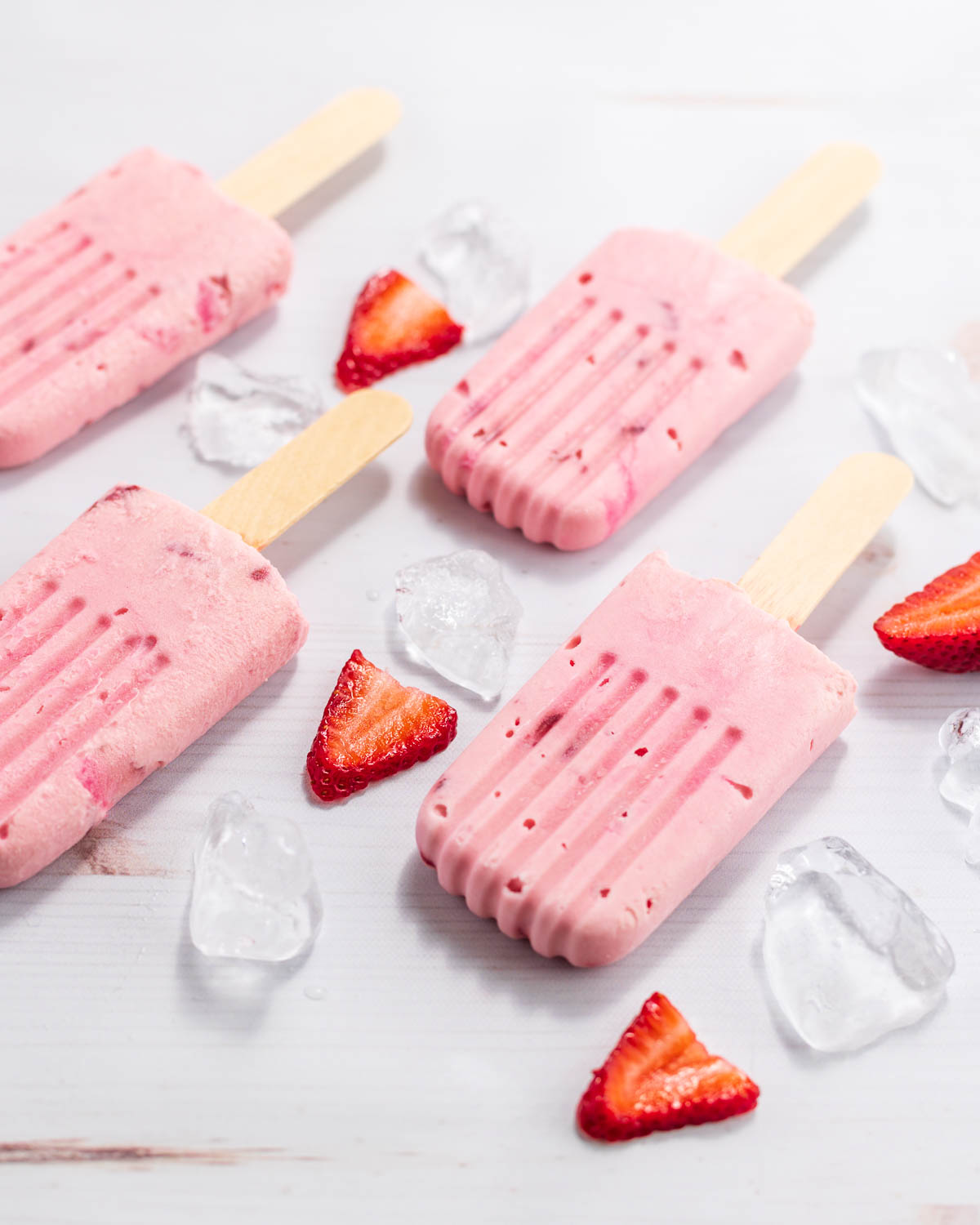 Low carb creamy strawberry creamsicles  with sliced berries and ice.