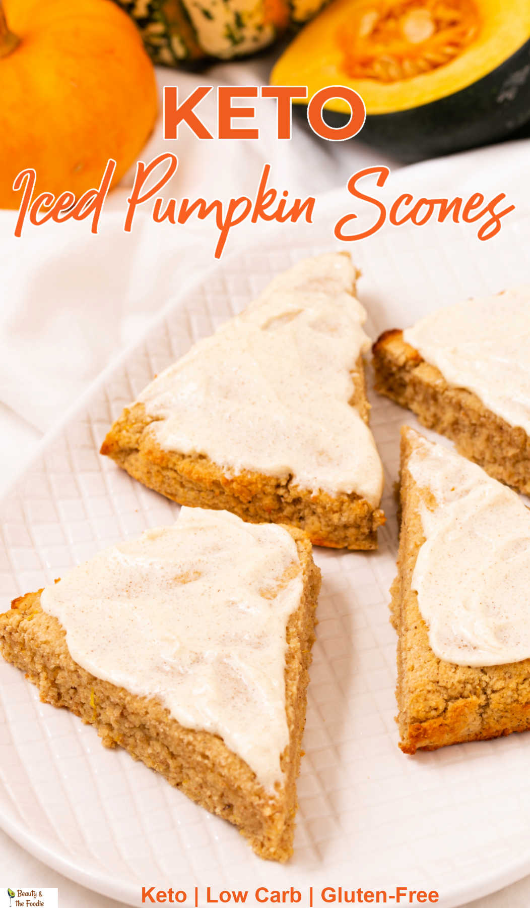 Iced pumpkin scones on a plate with  pumpkis  and squash in the background.