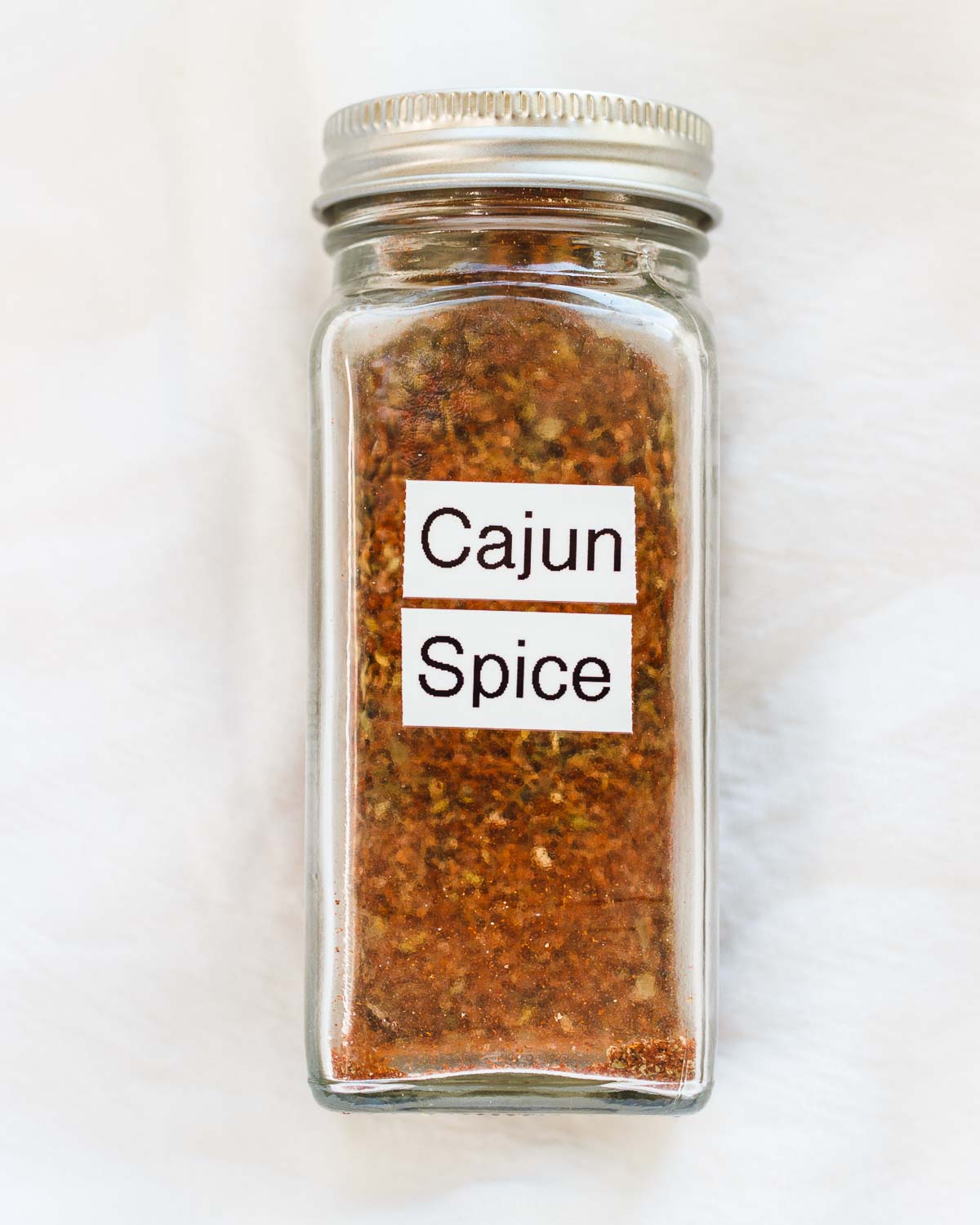 A labeled jar of homemade Cajun seasoning mix.