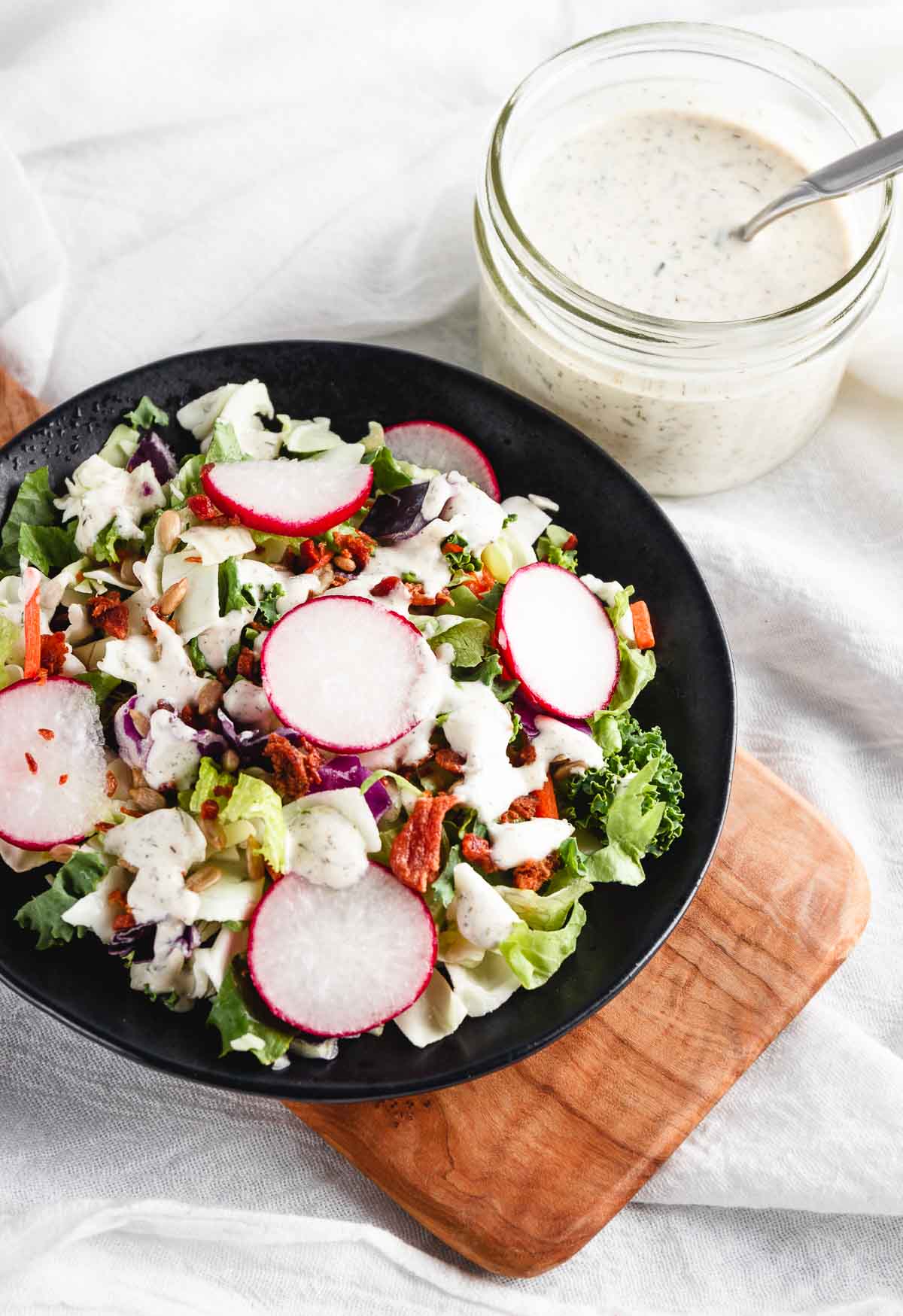 Serving a salad with the ranch dressing.