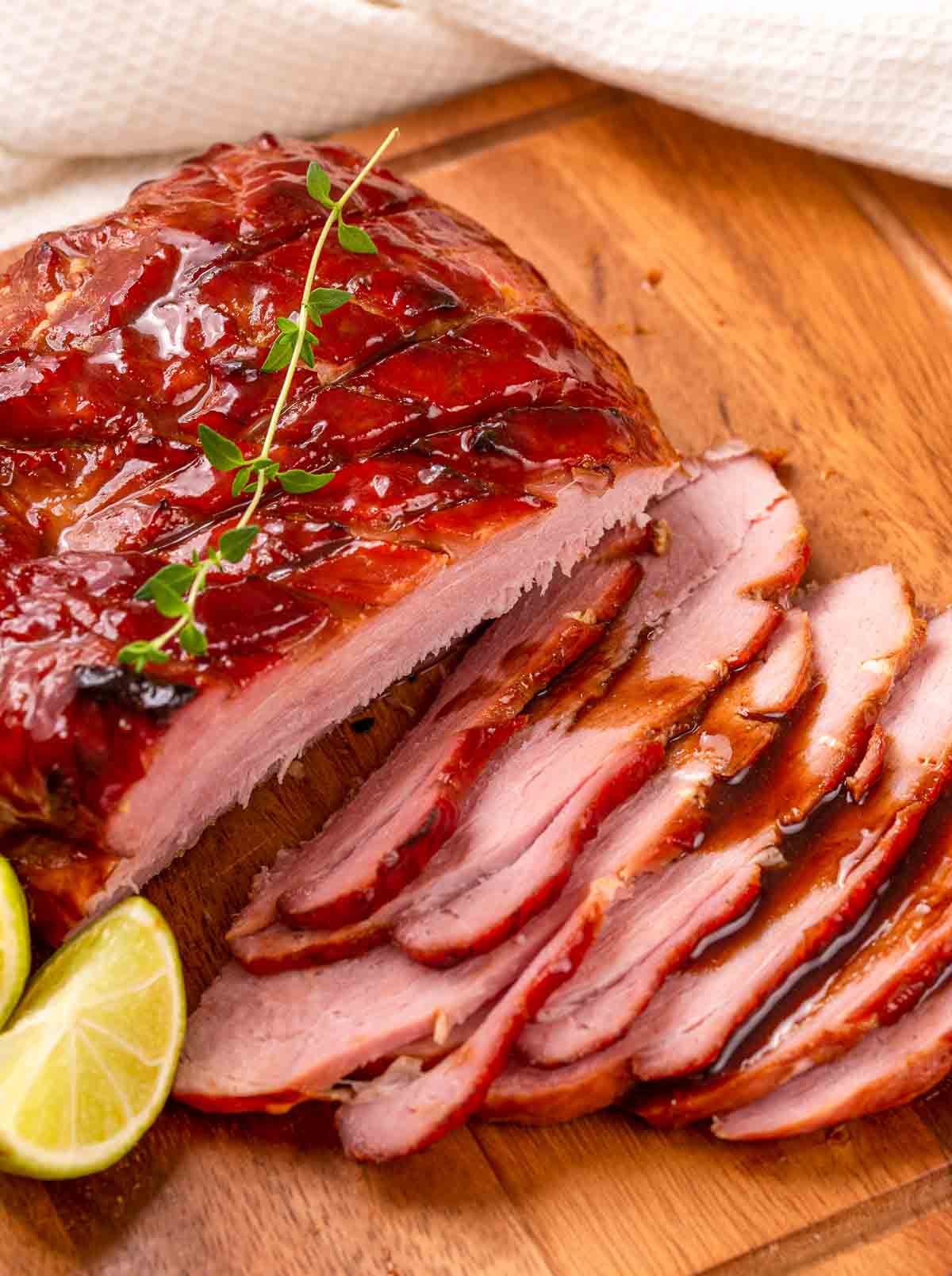 A keto maple cider glazed ham that has been sliced.