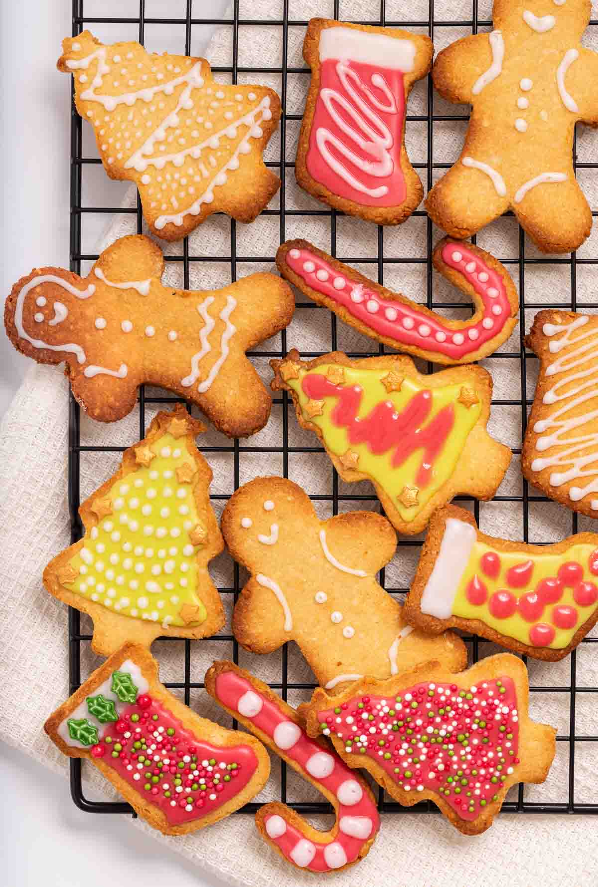 A plate of iced and decorated keto Christmas cookies.