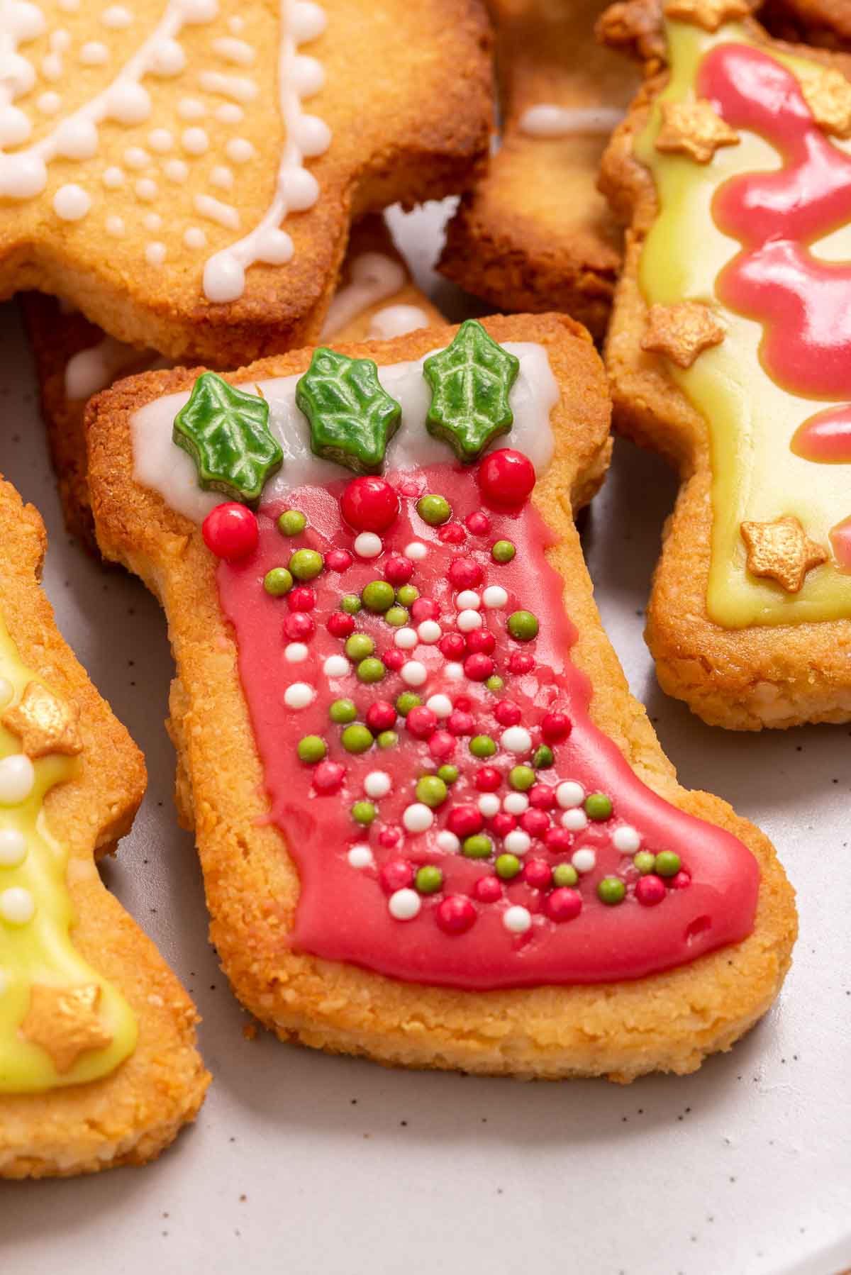 A plate of iced and decorated Christmas cookies.