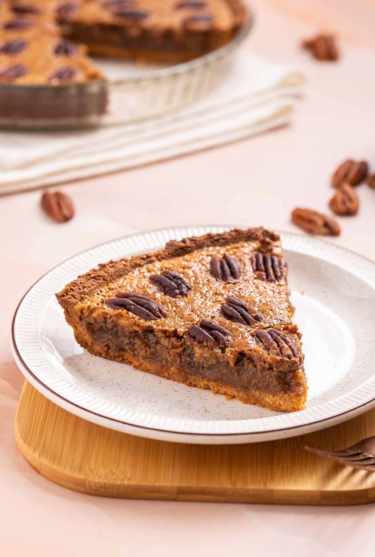 A keto pecan pie with a slice taken out of it.
