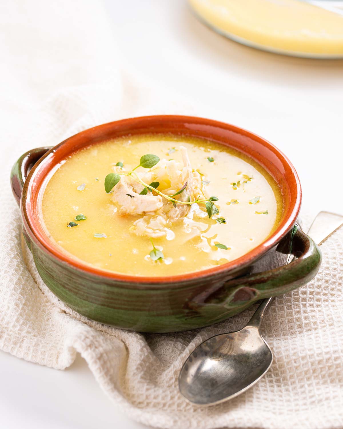 A bowl of Greek lemon chicken and cauliflower rice soup.