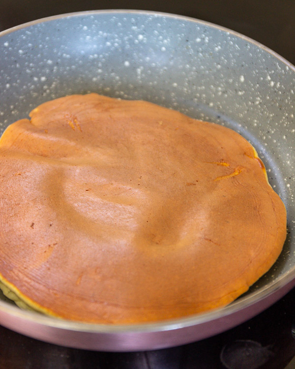 Cooking the other side of the pancake.