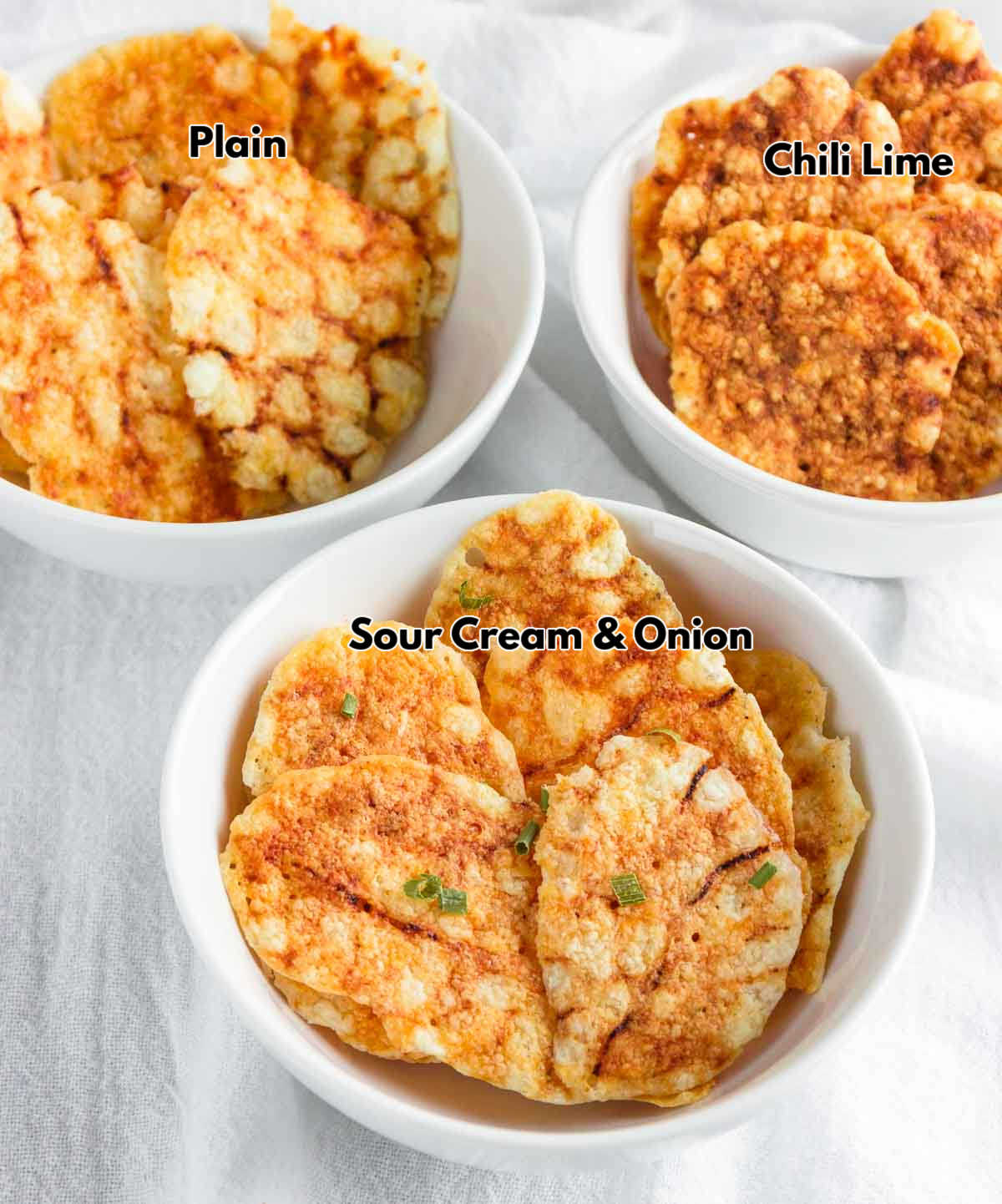 Three bowls of different flavors of keto cottage cheese chips.