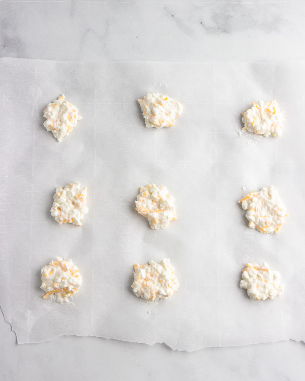 Placing small circle of cottage cheese on the parchment paper.