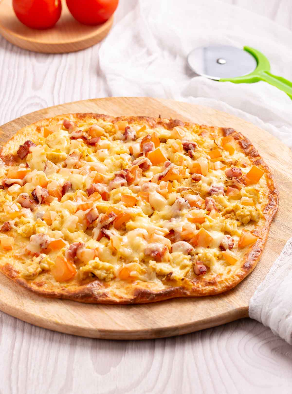 Scramble eggs, bacon , tomatoes and cheese and a low-carb pizza crust.