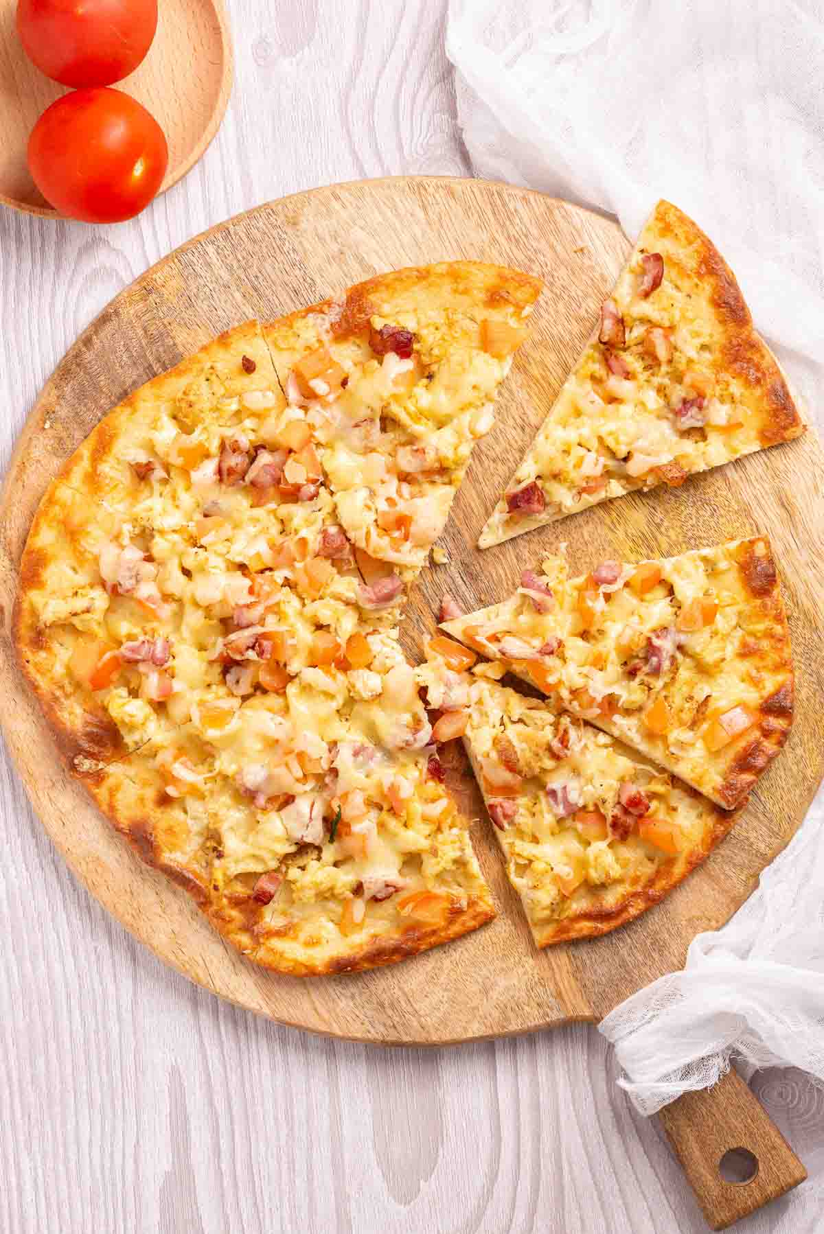 Scramble eggs, bacon , tomatoes and cheese and a low-carb pizza crust.