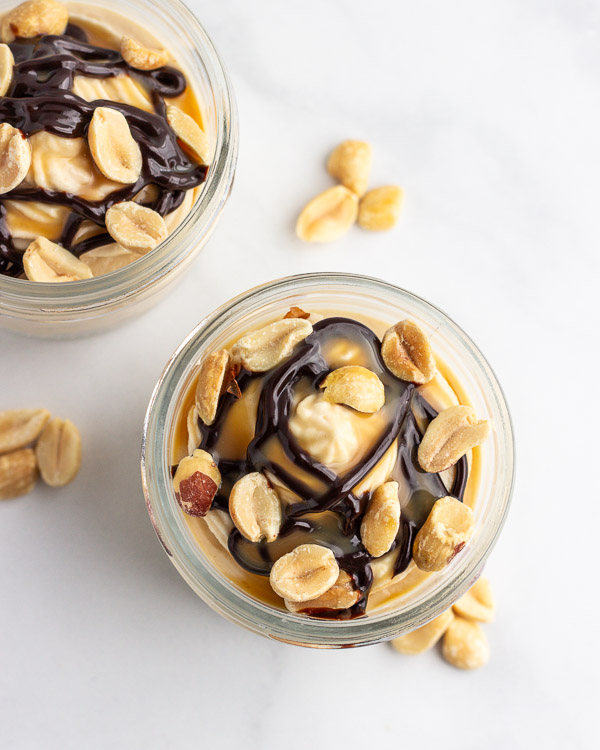 Drizzle chocolate and caramel syrups and sprinkle with peanuts.