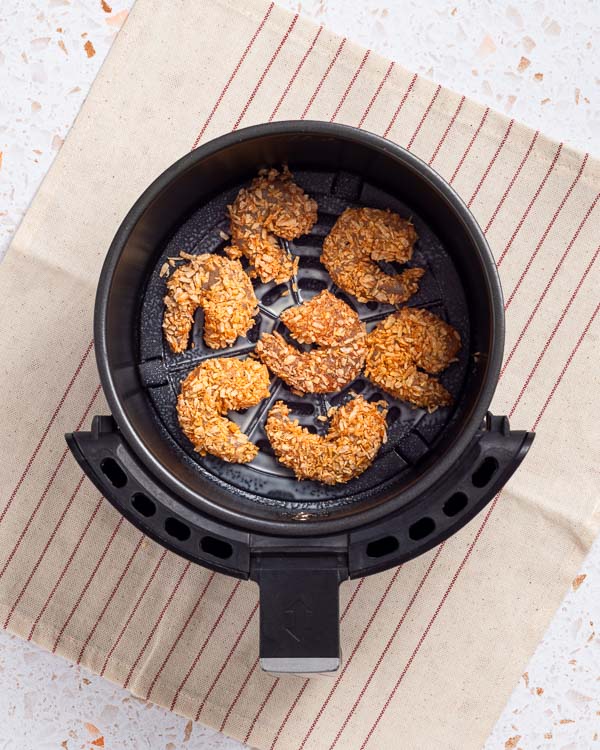 Placing the shrimp in the air fryer.