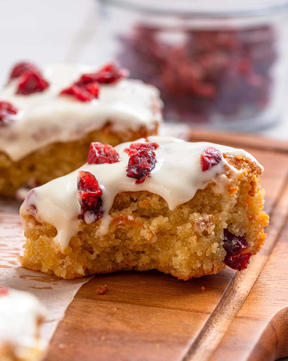 Low Carb Cranberry Bliss Bars with icing and dried cranberries.