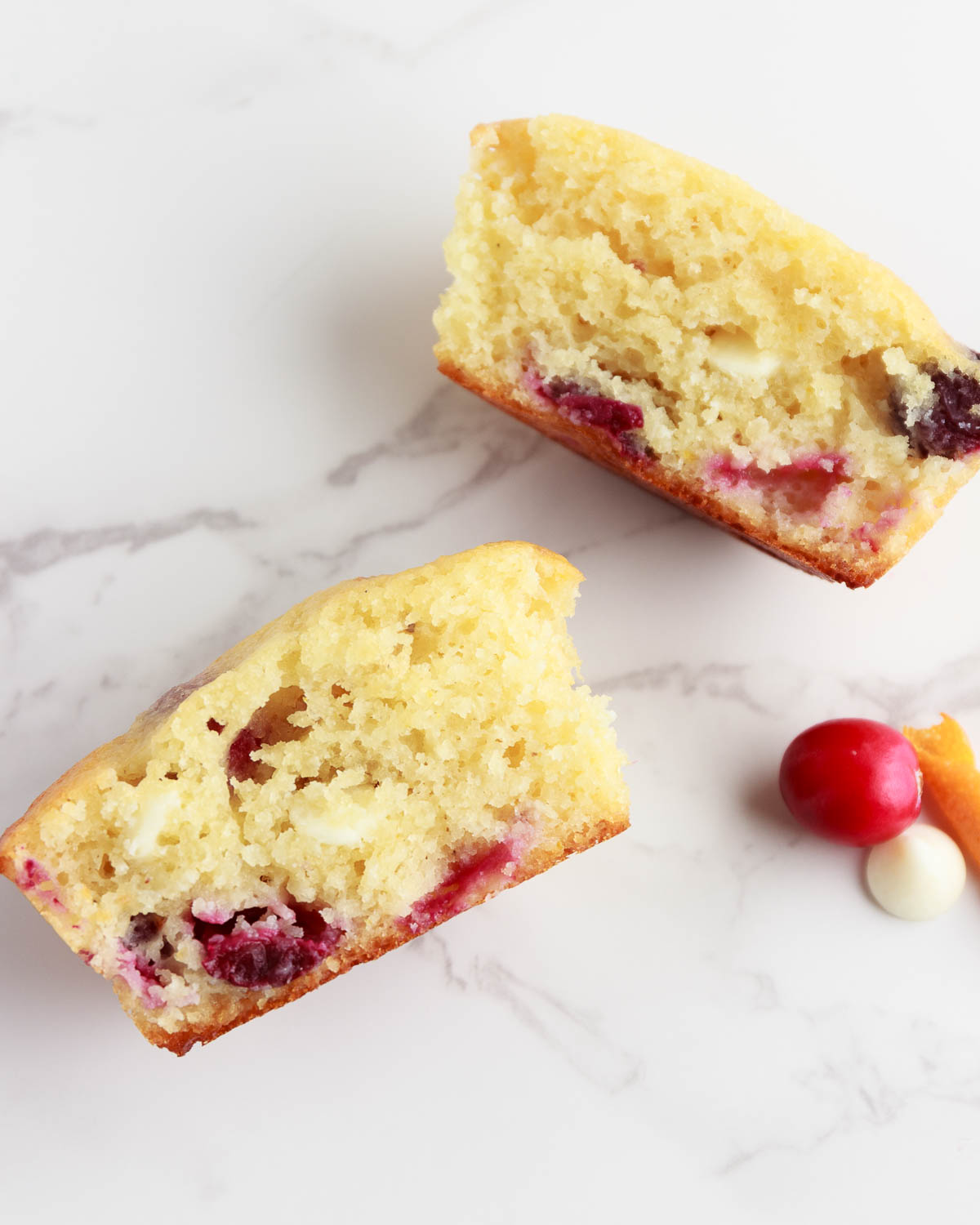 Keto Orange Cranberry Muffin with white chocolate chips and cut in half. .
