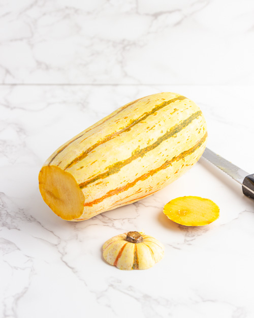 Cutting off the ends of the delicata squash.