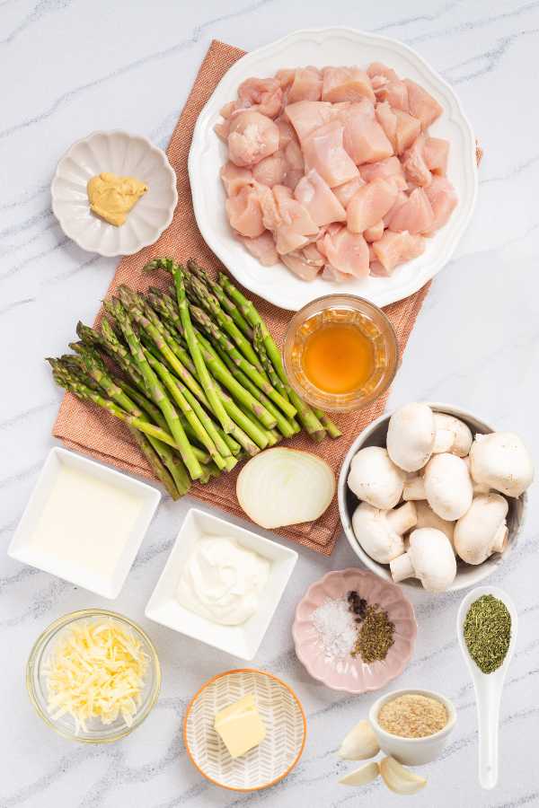 The ingredientts for making Keto Chicken Cheesy Asparagus Casserole.