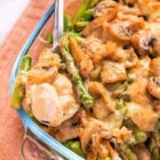 Keto Chicken Cheesy Asparagus Casserole with a spoonfull coming out of the dish.
