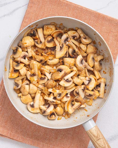 Sear mushrooms in a pan.