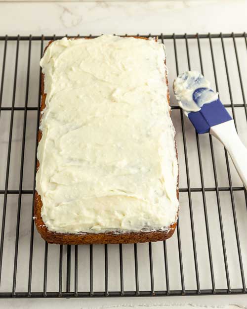 Frosting the bread loaf.