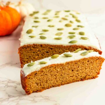 A frosted loaf of pumpkin bread with a cream cheese frosting.