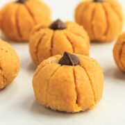 Keto pumpkin truffles in the shape of a pumpkin.