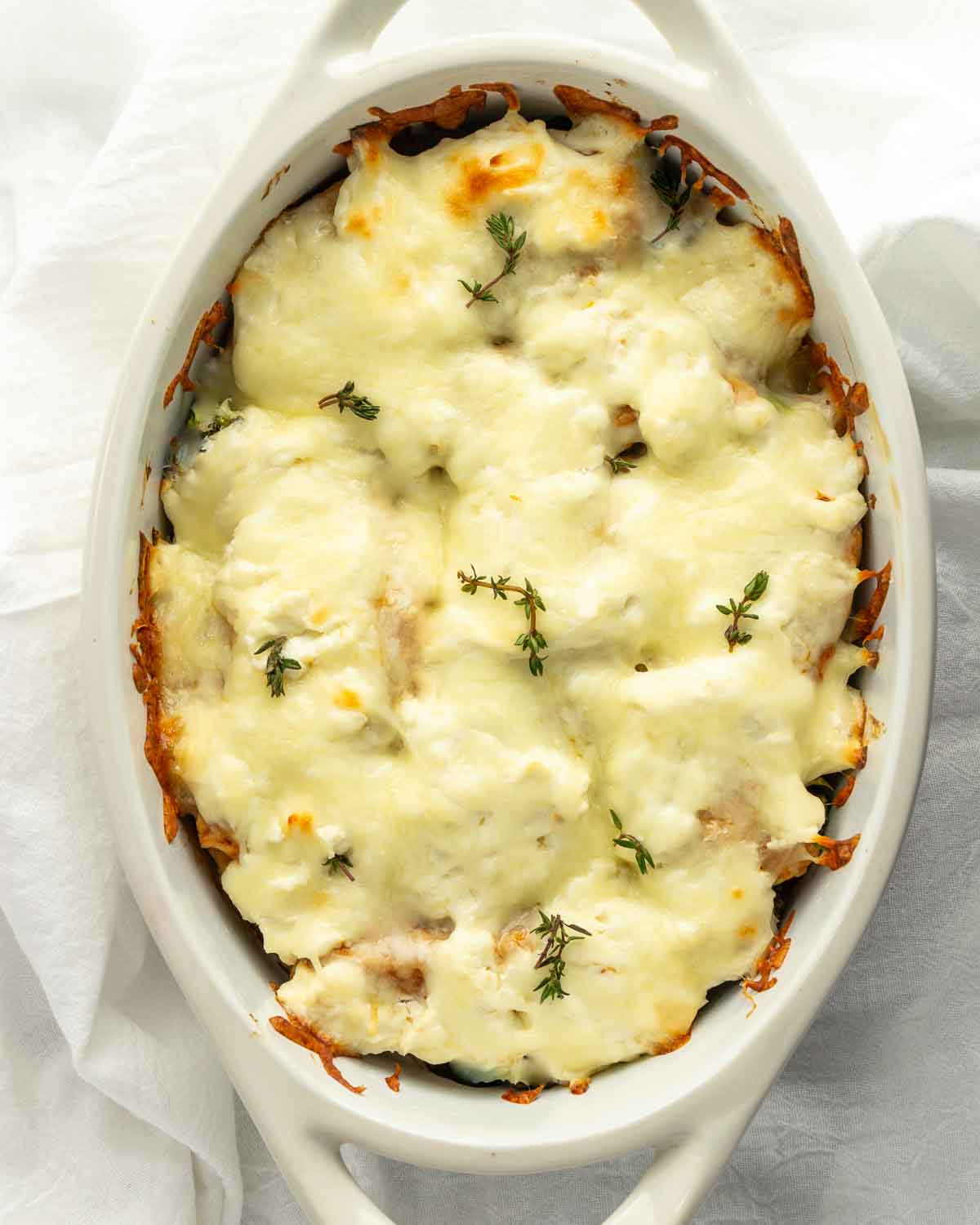 A casserole dish with chicken florentine bake in it.