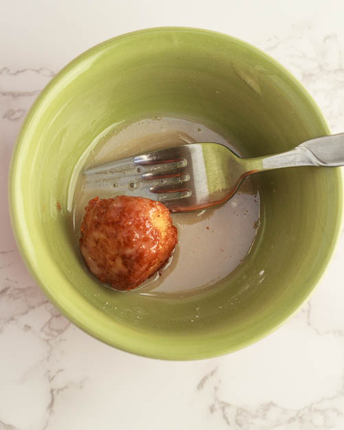 Roll the donut holes in the glaze.