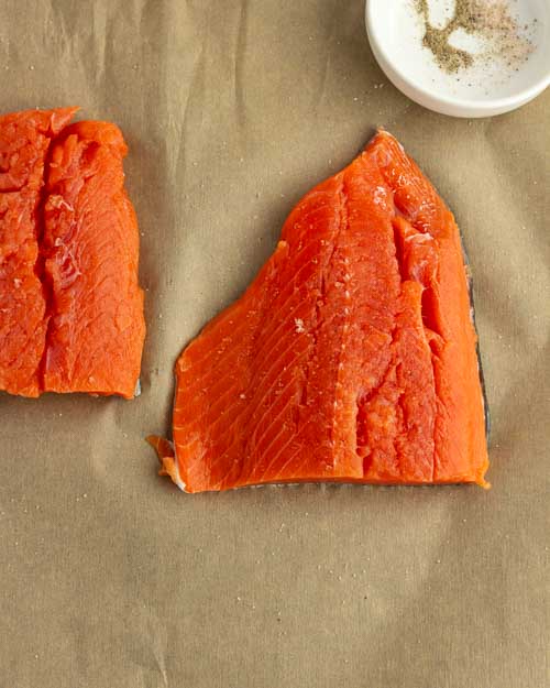 Seasoning the salmon.