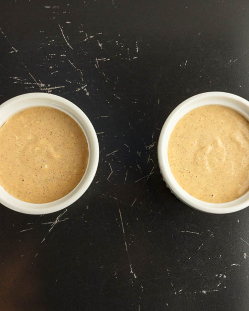 Pouring batter into the ramekins.