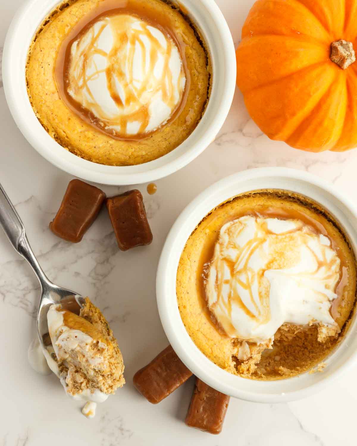 A bite on a spoon of keto mini pumpkin cheesecakes.