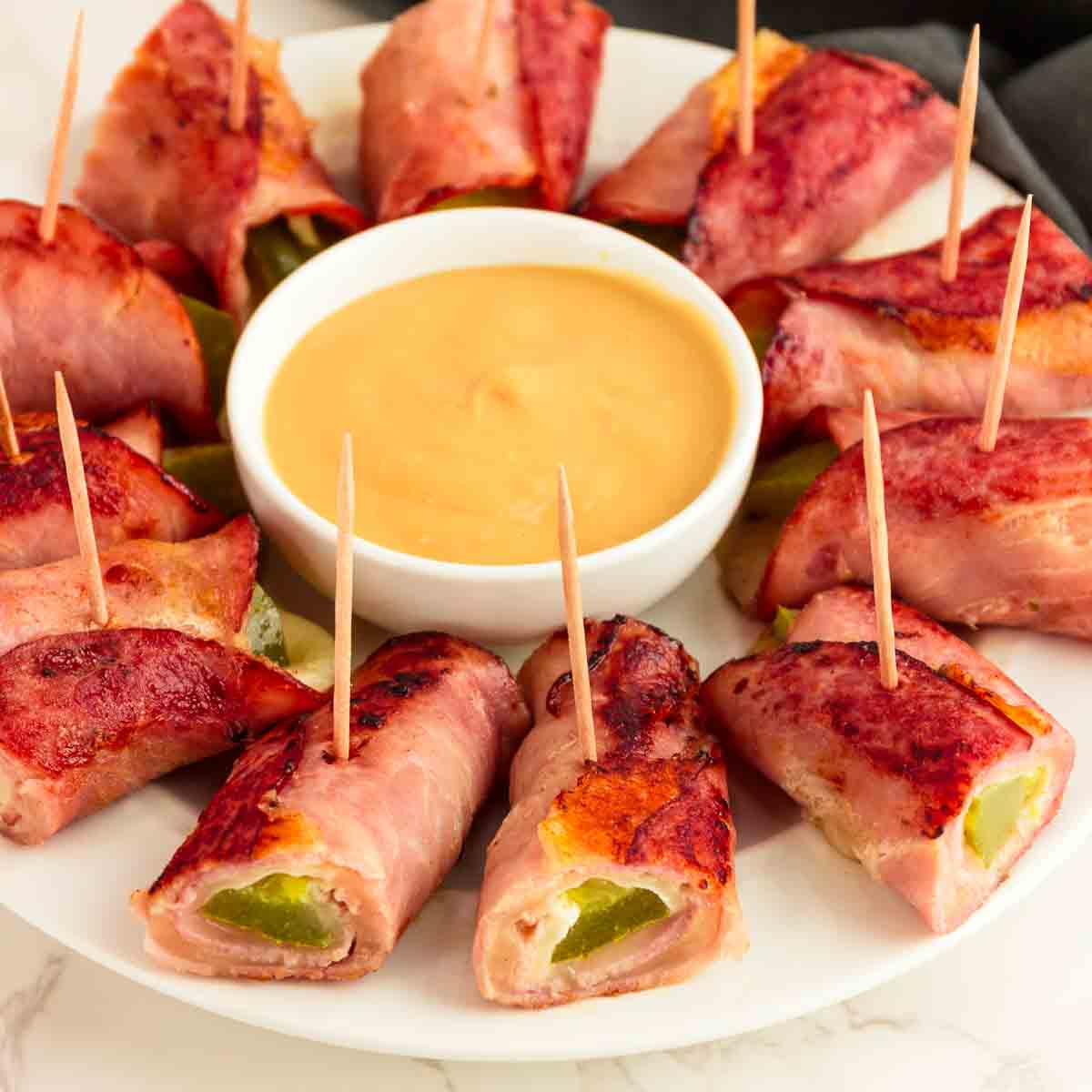 Plating and serving the roll ups with a dipping sauce.