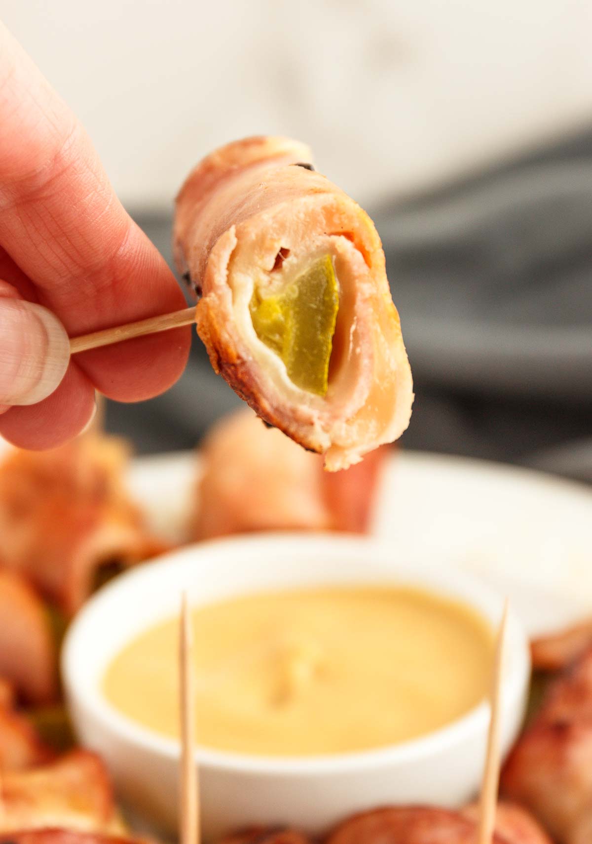 Holding a Cubano Roll Up with a toothpick.