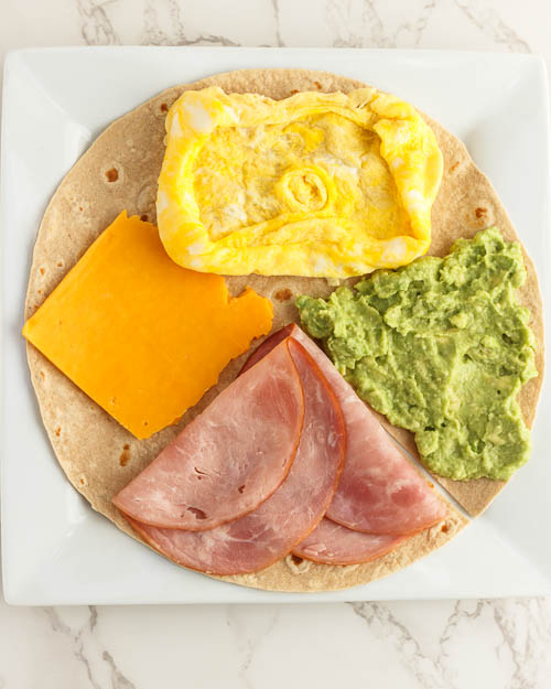 Placing the fillings on the tortilla.