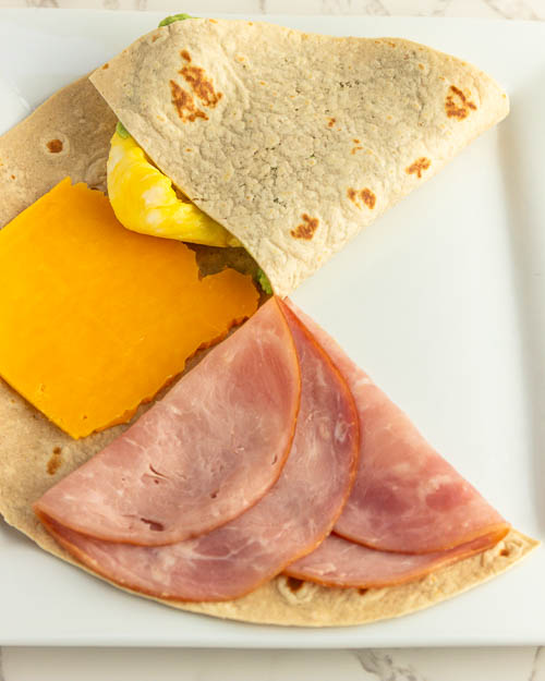 Folding the sections of the tortilla.