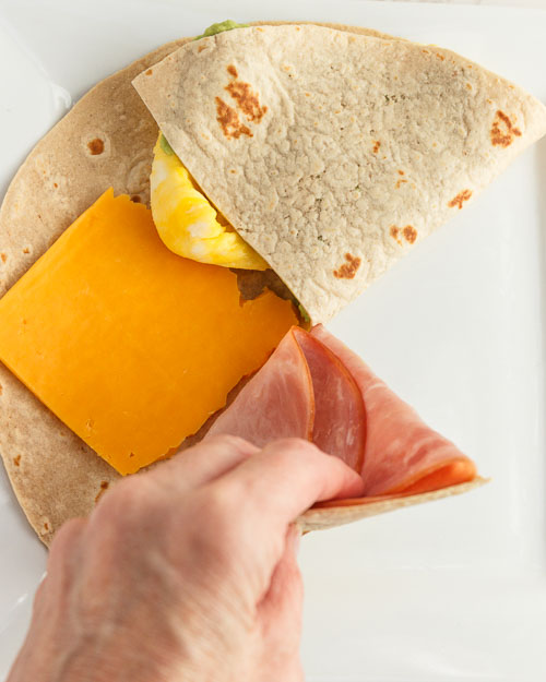 Folding the tortilla wrap.