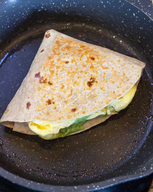Frying the breakfast tortilla wraps.