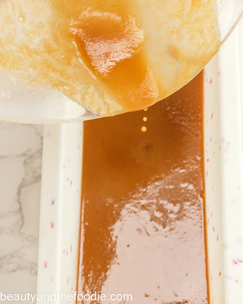 Pouring the caramel into a loaf pan.