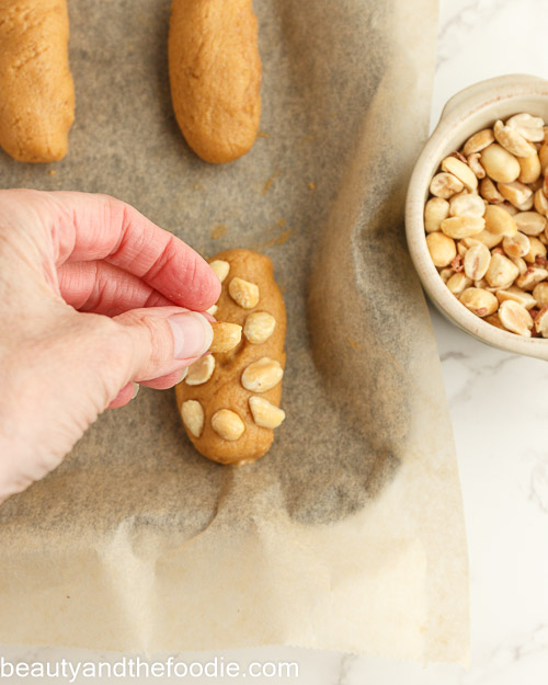Adding the peanuts to the bars.
