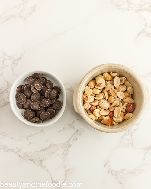 Peanuts and chocolate chip garnish for making keto payday bars.
